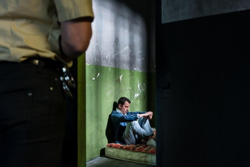 man in lockdown inside prison cell